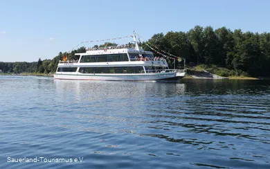 Weißes Personenschiff fährt auf dem sommerlichen Sorpesee